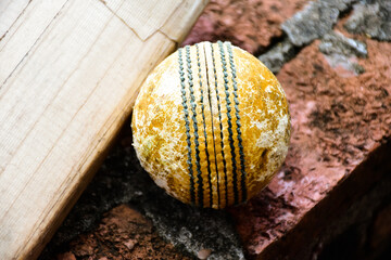 Cricket sport equipments on brick, bat, wicket, old leather ball, soft and selective focus. - obrazy, fototapety, plakaty