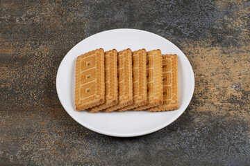 Pile of tasty biscuits on white plate