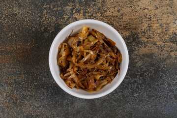 Caramelized onion pieces in white bowl