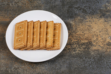 Pile of tasty biscuits on white plate