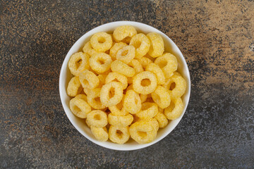 Tasty cereal rings in white bowl