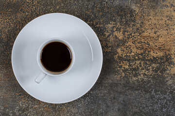 Cup of black coffee on marble background