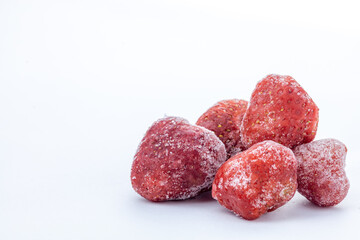 heap of frozen strawberry on white background with copy space 
