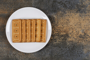 Pile of tasty biscuits on white plate