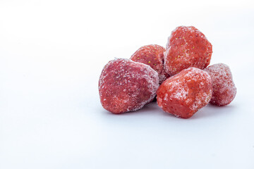 heap of frozen strawberry on white background with copy space 