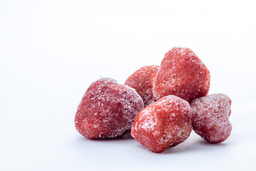 heap of frozen strawberry on white background with copy space 