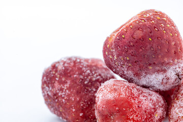 Close-up of frozen strawberries covered in frost.  Perfect for food blogs, recipes, or frozen food packaging.