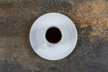 Cup of black coffee on marble background