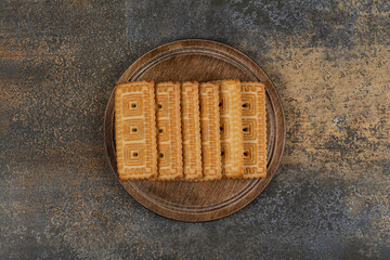 Pile of tasty biscuits on wooden board