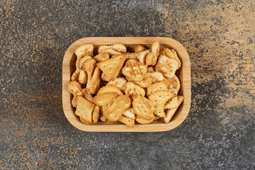 Variety of salted crackers in wooden bowl