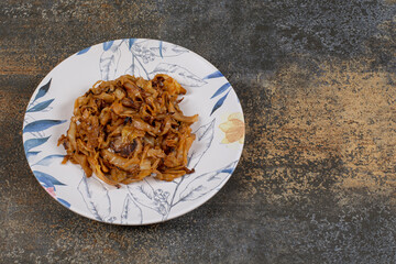 Caramelized onion pieces on colorful plate