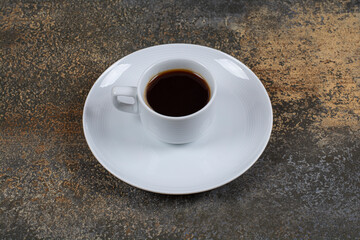 Cup of black coffee on marble background