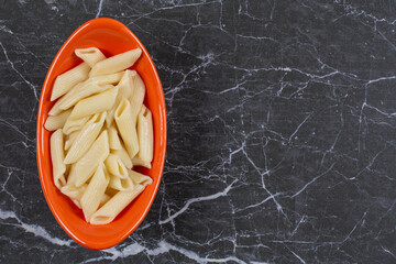 Boiled fresh penne pasta in bowl