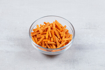Fresh fries in glass bowl over white background
