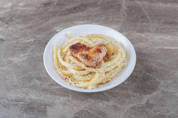 Spaghetti with tomato sauce in a bowl , on the marble background