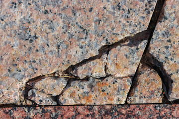 The surface of granite stone with cracks.