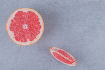 Top view of fresh grapefruit on grey background