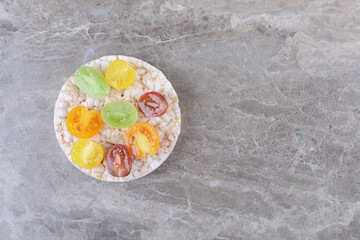 Different kinds of fruits on the puffed rice cakes, on the marble background