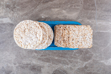 Some rice cakes on the board, on the marble background