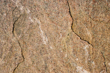 Damaged stone slabs with cracks close-up.