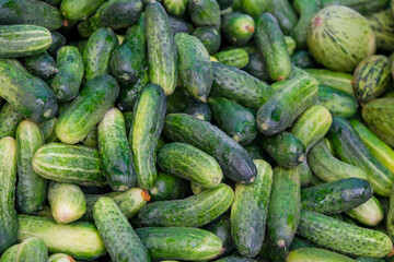 Vegetables and cucumbers are ready for sale in the village market.