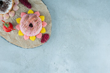 Two doughnuts with pinecones and sweet jelly candies