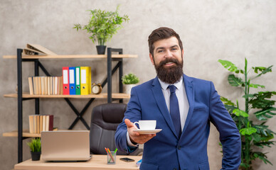 happy mature entrepreneur in jacket having coffee break at office, lunch break
