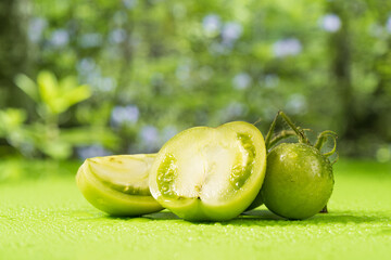 Fresh green tomatoes on a solid background
