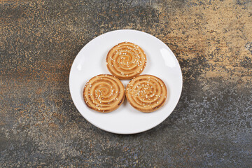 Yummy sesame seeds biscuits on white plate