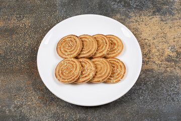Sesame seeds biscuits on white plate