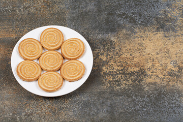 Pile of tasty biscuits on white plate