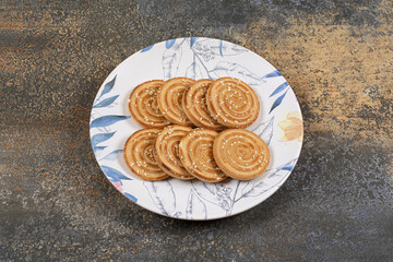 Several tasty biscuits on colorful plate
