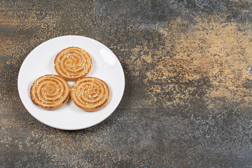 Yummy sesame seeds biscuits on white plate