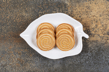 Plate of sesame seeds biscuits on marble background