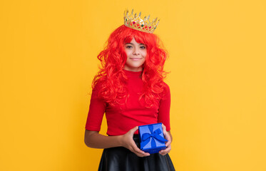 positive child in crown with present box on yellow background