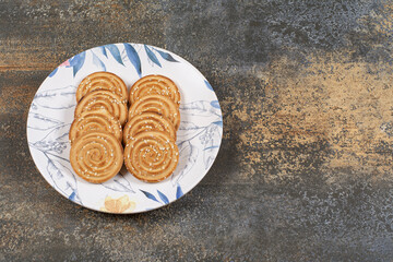 Several tasty biscuits on colorful plate