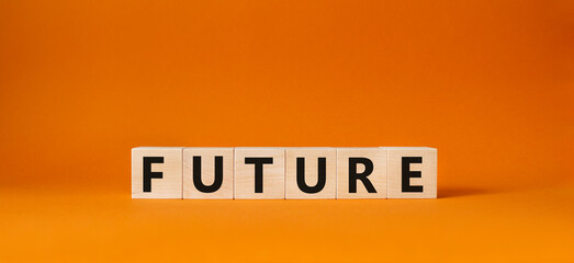 Future symbol. Concept word Future on wooden cubes. Beautiful orange background. Business and Future concept. Copy space.