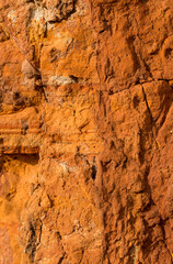 Sedimentary rocks with a high content of iron oxide. Red soil, loam. The texture of the soil.