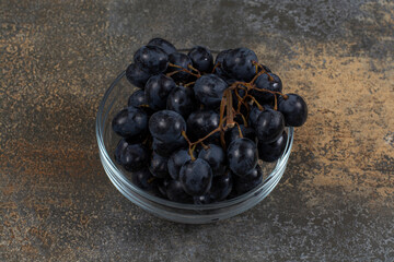 Fresh black grapes in glass bowl