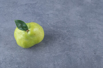 Fresh organic green per with leaf on grey background