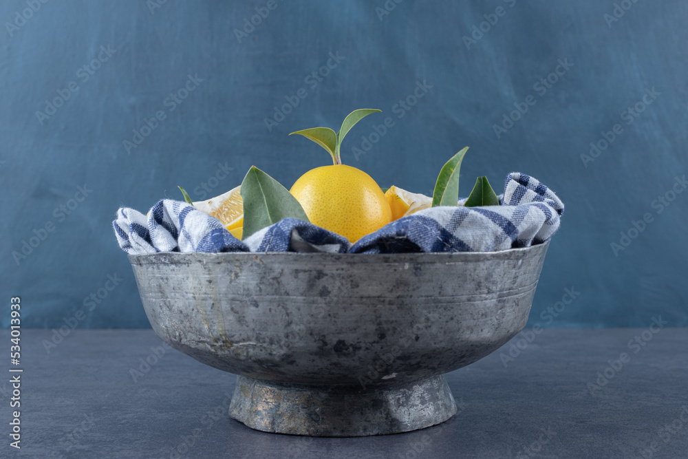 Wall mural Iron old bowl full of fresh lemons