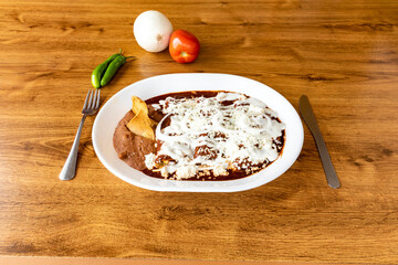 Homemade enmoladas are a type of enchiladas made with mole instead of sauce.