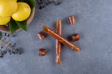 top view of lemons in bowl over grey background