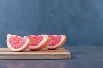 Fresh organic Grapefruit slices on wooden board