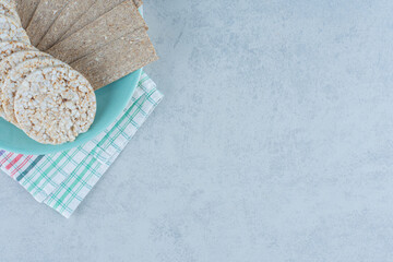 Delectable crispbread in the plate on the tower, on the marble background