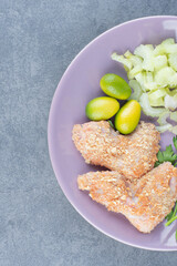 Raw chicken wing nuggets on purple plate