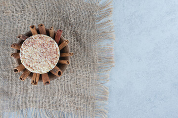 Cinnamon and rice cake in the bowl, on the marble background