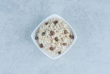 Rice with milk and coffee beans , on the marble background