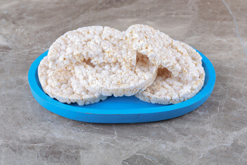 Some rice cakes on the board, on the marble background