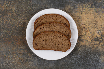 Rye black bread slices on white plate